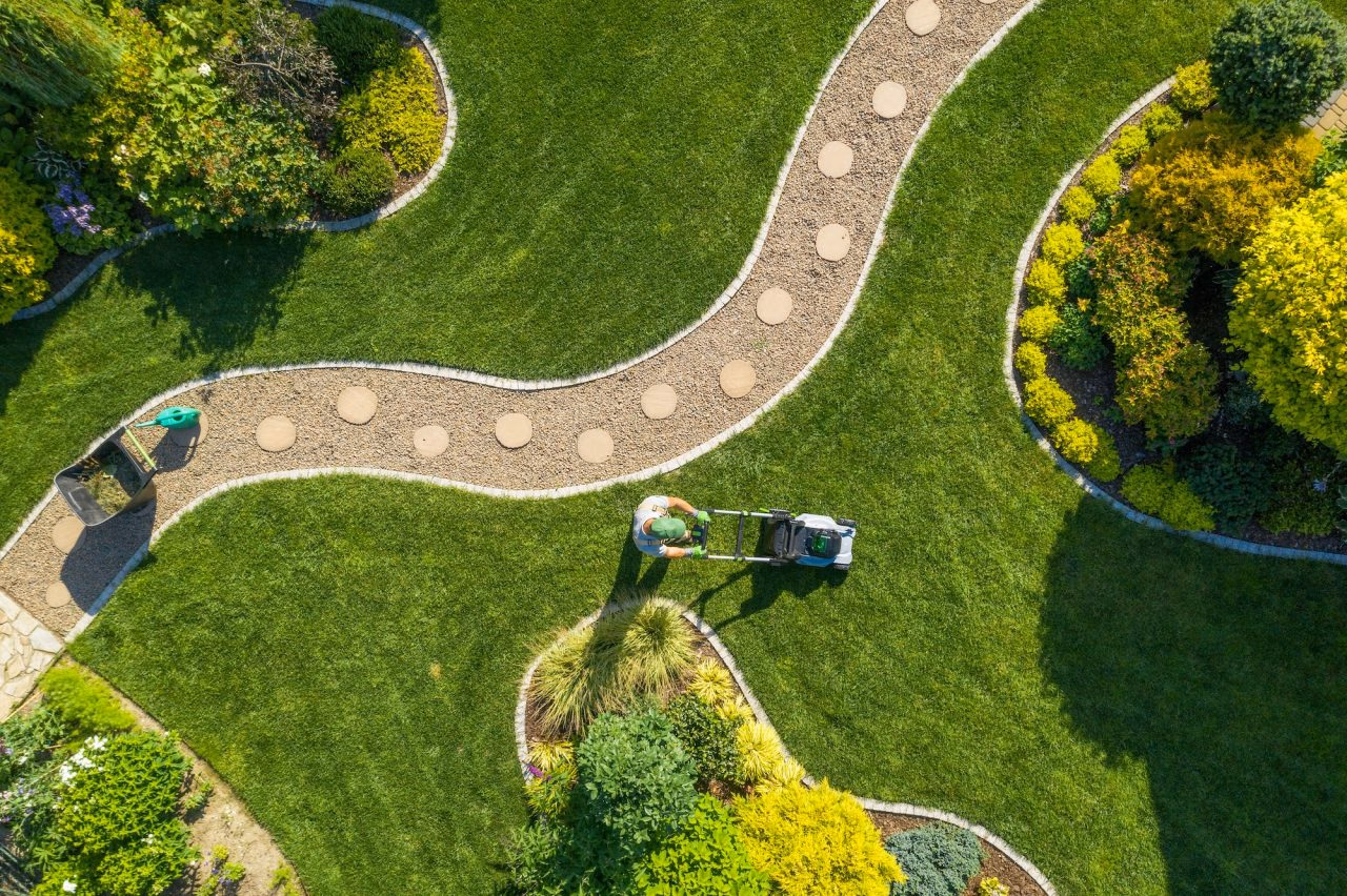 Aerial view of a landscaped garden with a curving path through green lawn